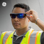 black/indigo, Blue Mirror Anti-Fog | model wearing glasses with safety vest | Anti-Fog Wrap-Around Safety Glasses — GE PPE 09 Series, ANSI Z87.1 & EN 166 | GE109BAF