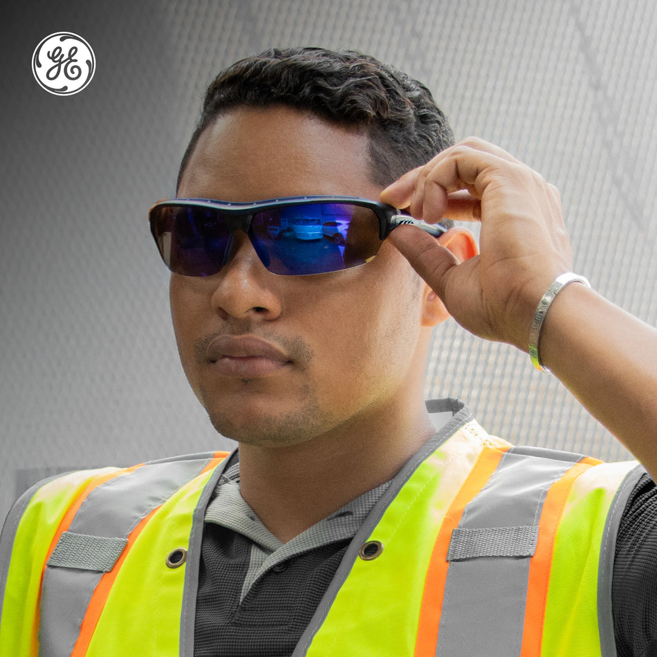 black/indigo, Blue Mirror Anti-Fog | model wearing glasses with safety vest | Anti-Fog Wrap-Around Safety Glasses — GE PPE 09 Series, ANSI Z87.1 & EN 166 | GE109BAF