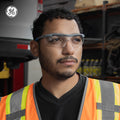 gray/blue, Clear Anti-Fog | model wearing glasses in industrial setting | Wrap-Around Safety Glasses — GE PPE 01 Series, ANSI Z87.1 | GE101CAF