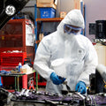 l | person wearing coverall in industrial setting | GE PPE GW903 Microporous Protective Coverall Hood & Boots | GW903L