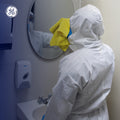 s | person wearing coveralls cleaning bathroom mirror | SMS Disposable Hooded Coverall Type 5/6 — GE PPE GW901, EN 13982-1, Elastic Wrists & Ankles | GW901S