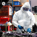 s | person wearing protective suit in workshop | Microporous Disposable Coverall Type 5/6 — GE PPE GW904, 63 GSM, Elastic Hood | GW904M